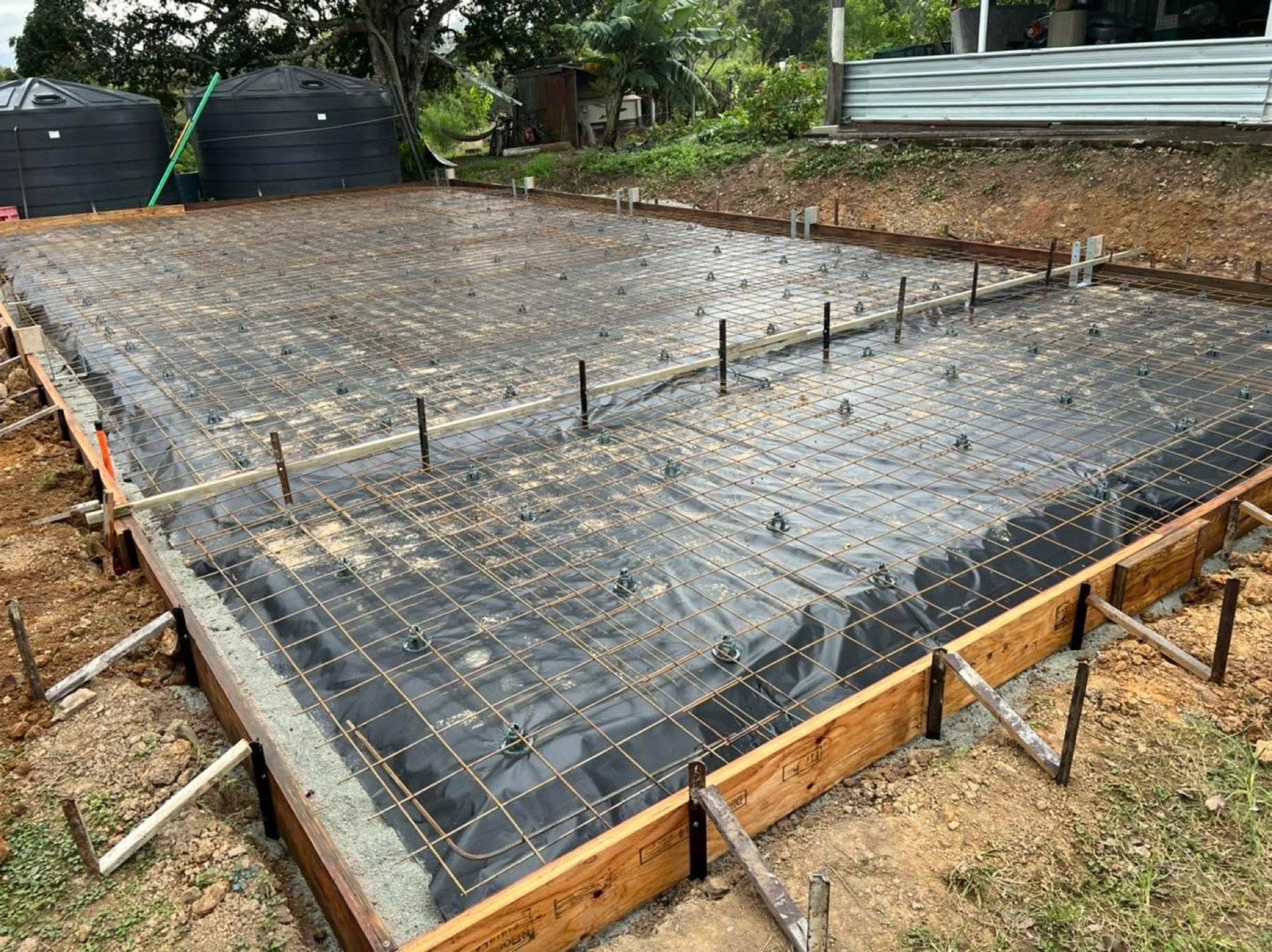 Steel mesh and formwork set out on plastic ready for a concrete pour