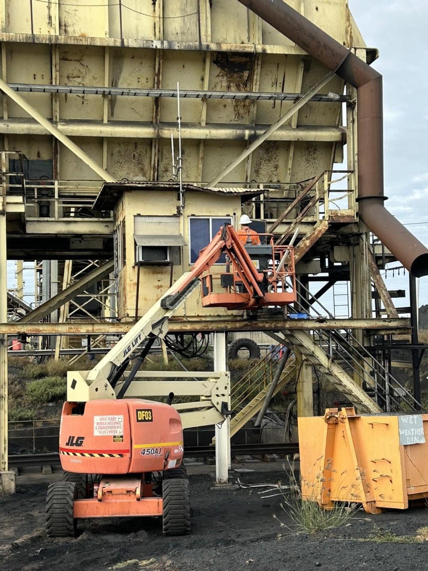 An elevated work platform beside industrial plant and steelwork at a Central Queensland site