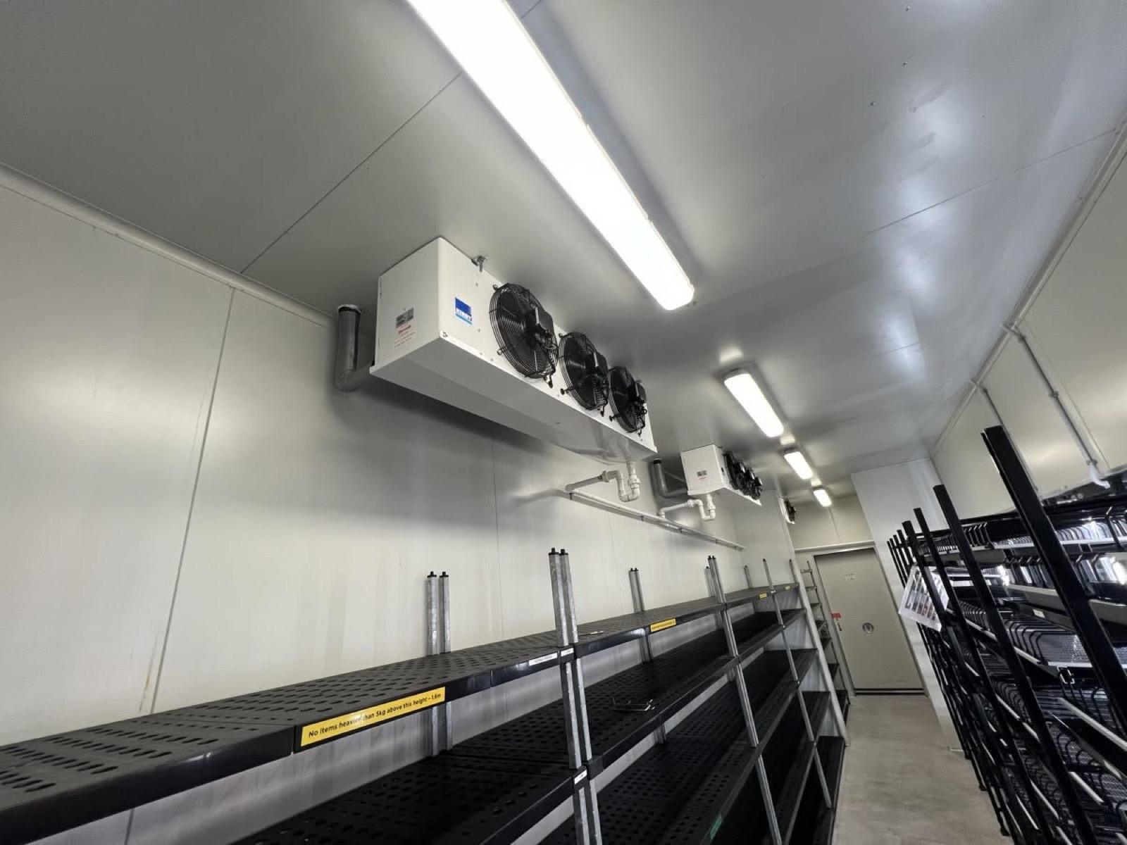 A finished cool room with evaporator units mounted above the shelving