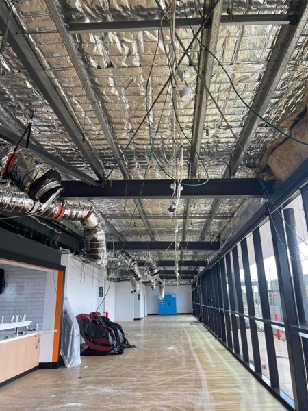 Ductwork and services run through an open ceiling during a fit-out