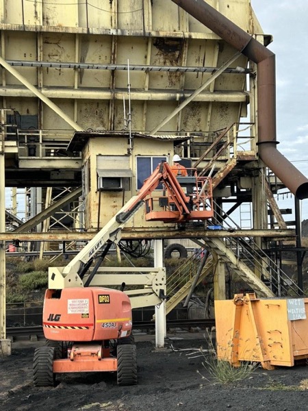 An elevated work platform beside industrial plant and steelwork