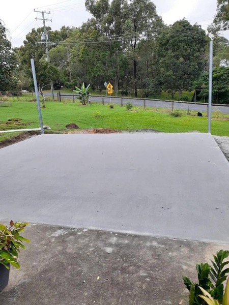 A finished concrete driveway running out to the street
