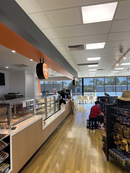 A service station shop fit-out with a food counter and display fridges