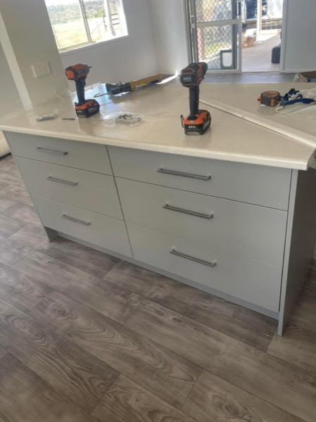 A new kitchen island being installed with tools on the benchtop
